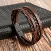A dark brown leather bracelet featuring multi-layered strands of tiger eye beads resting on a dark surface.
