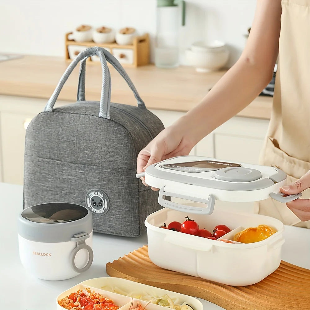 A hand is holding a white insulated food container and a gray lunch bag next to a wooden cutting board.