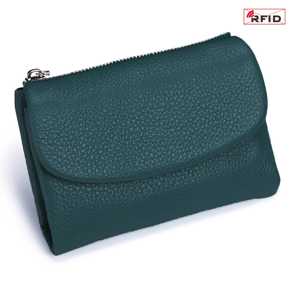 A dark teal genuine leather mini card holder wallet with a zipper closure.