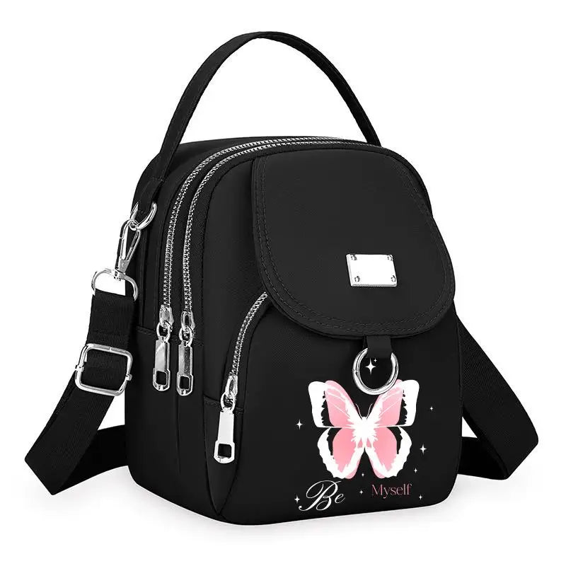 Sac bandoulière noir floral avec fermeture éclair et quincaillerie argentée.