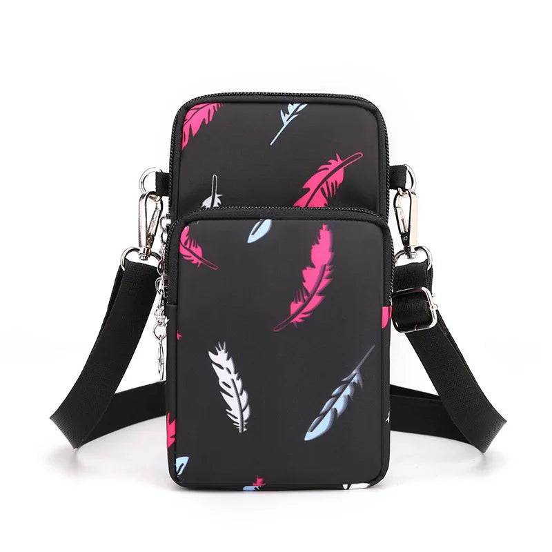 Black nylon crossbody phone bag featuring a pattern of pink and blue feathers.