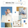 A white canvas tote bag with brown leather accents is shown being held by a woman.