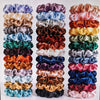 A display of 19 thin scrunchies hair ties in various shades of purple, pink, green, and brown.