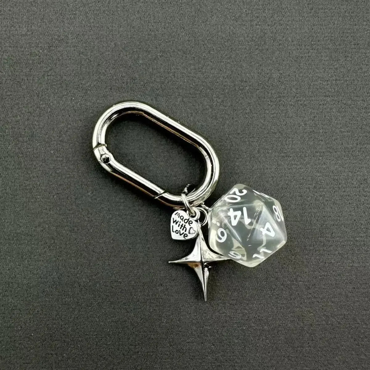 Silver keychain featuring a clear resin die with the number 20 and a star charm