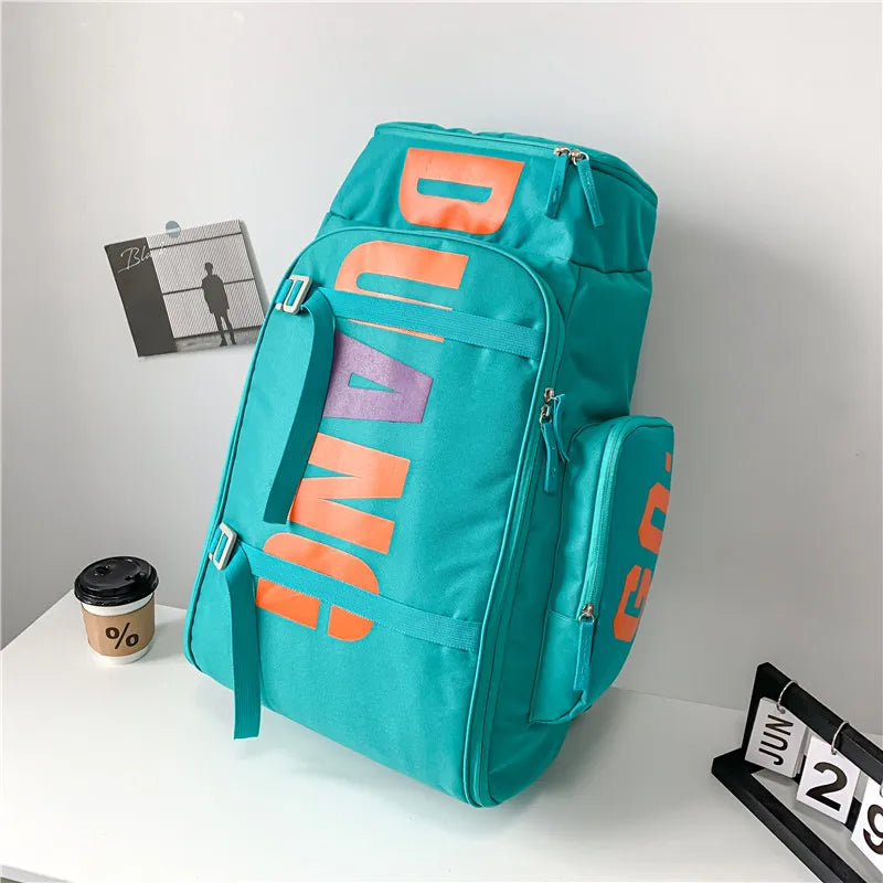A teal backpack featuring orange text and skateboard straps, displayed on a white surface.