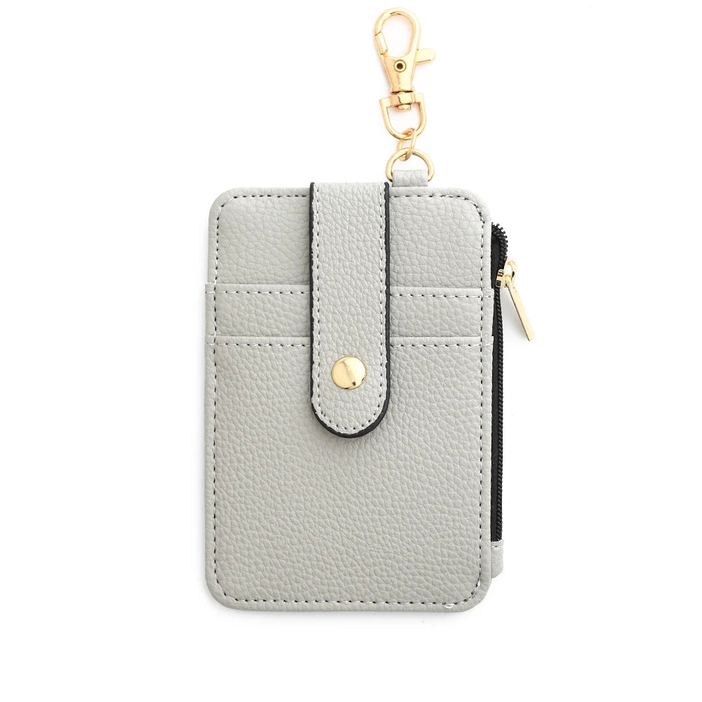 A light gray silicone PU leather key chain wristlet wallet with a black zipper and gold-tone hardware.