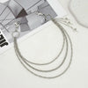 Silver punk star chain belt featuring multiple linked chains and pearl accents displayed on a white surface.