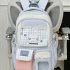 A light blue and pink Oxford backpack featuring a cat design and a laptop compartment.