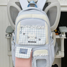 A light blue and pink Oxford backpack featuring a cat design and a laptop compartment.