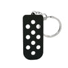 Porte-clés en silicone noir pour chaussure avec trou circulaire et anneau argenté.
