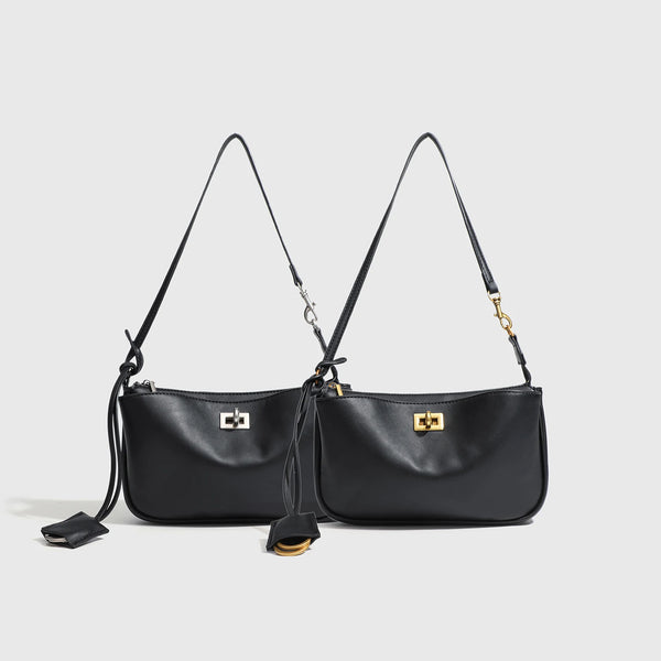 A black classic split leather shoulder tote bag with gold hardware displayed against a light gray background.