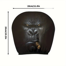 Una funda para reposacabezas de coche de silicona oscura con forma de cara de gorila, vista desde el frente.