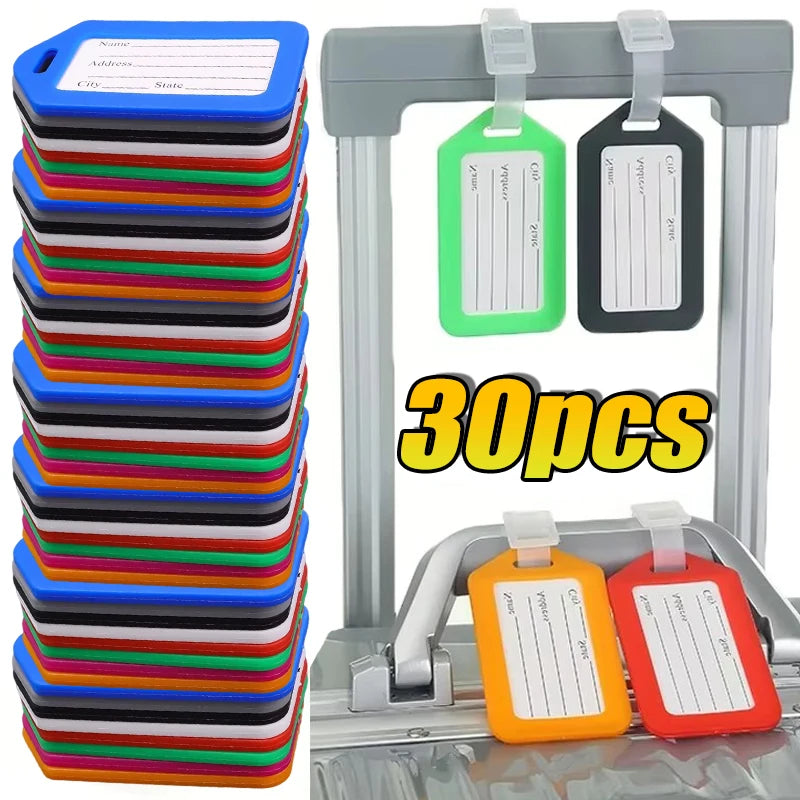 A set of 30 customizable luggage tags in various colors, including green, black, and orange, displayed on a metal rack.