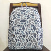 A gray and white camouflage patterned toddler backpack displayed on a wooden hanger.