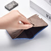 A hand opens a brown leather wallet with blue accents, showing the interior and card slots.