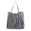 A navy and cream striped canvas tote bag with a drawstring handle.