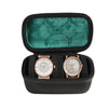Black watch organizer case with a green velvet lining and two watch slots.