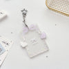 Clear acrylic photocard holder with a silver charm and purple ribbon decoration