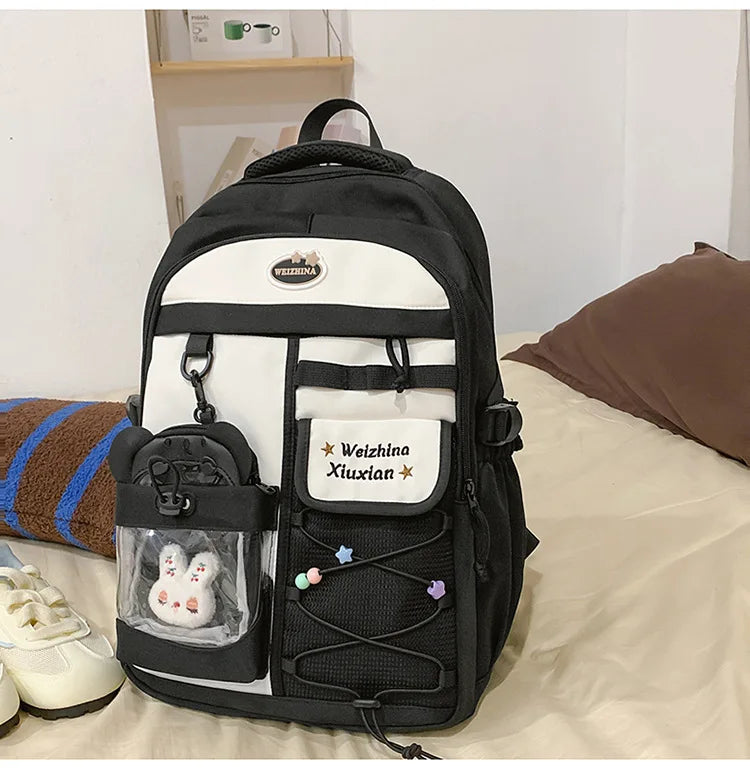 A black and white Candy Color Campus backpack for women with a beige lining and decorative details.
