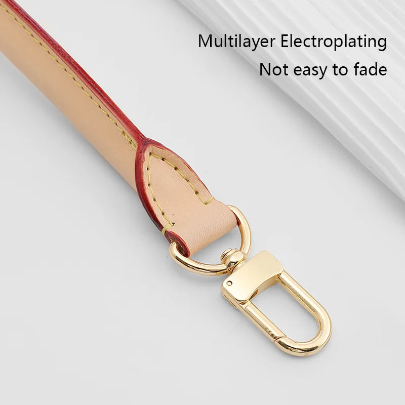 A light tan genuine Vachetta leather bag strap with a gold-toned metal clasp.