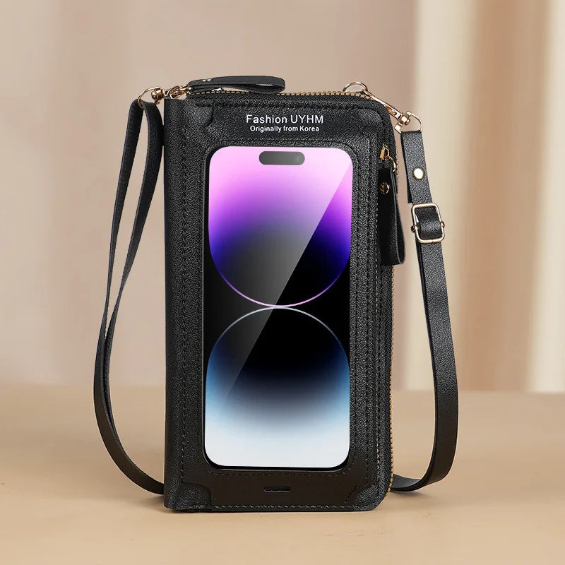 Schwarze Mode-Handytasche mit klarem Display und goldfarbenem Zierwerk vor hellem Hintergrund.