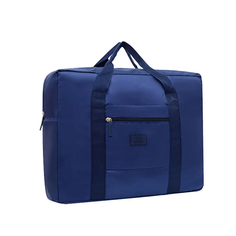 Navy blue foldable travel duffel bag with a luggage strap and zippered compartment