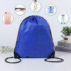 A royal blue drawstring backpack is shown with various items like a smartphone, sunglasses, and perfume bottles arranged arou