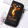 A black zippered pouch featuring an orange tiger design and the text The Tiger Forever resting on a white background.