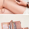 A close-up of a brown leather trifold clutch wallet with various card slots and a gold-toned clasp.