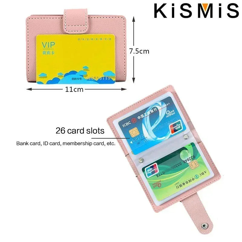 A pink leather card holder with a clear plastic sleeve showing 26 card slots and dimensions.