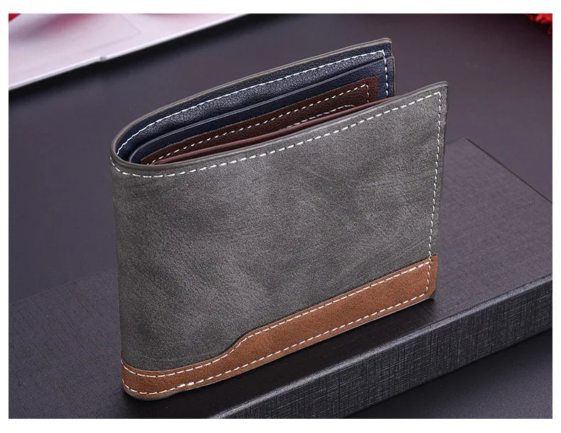 A grey retro PU leather men's wallet with brown stitching and a leather card holder displayed on a dark surface.