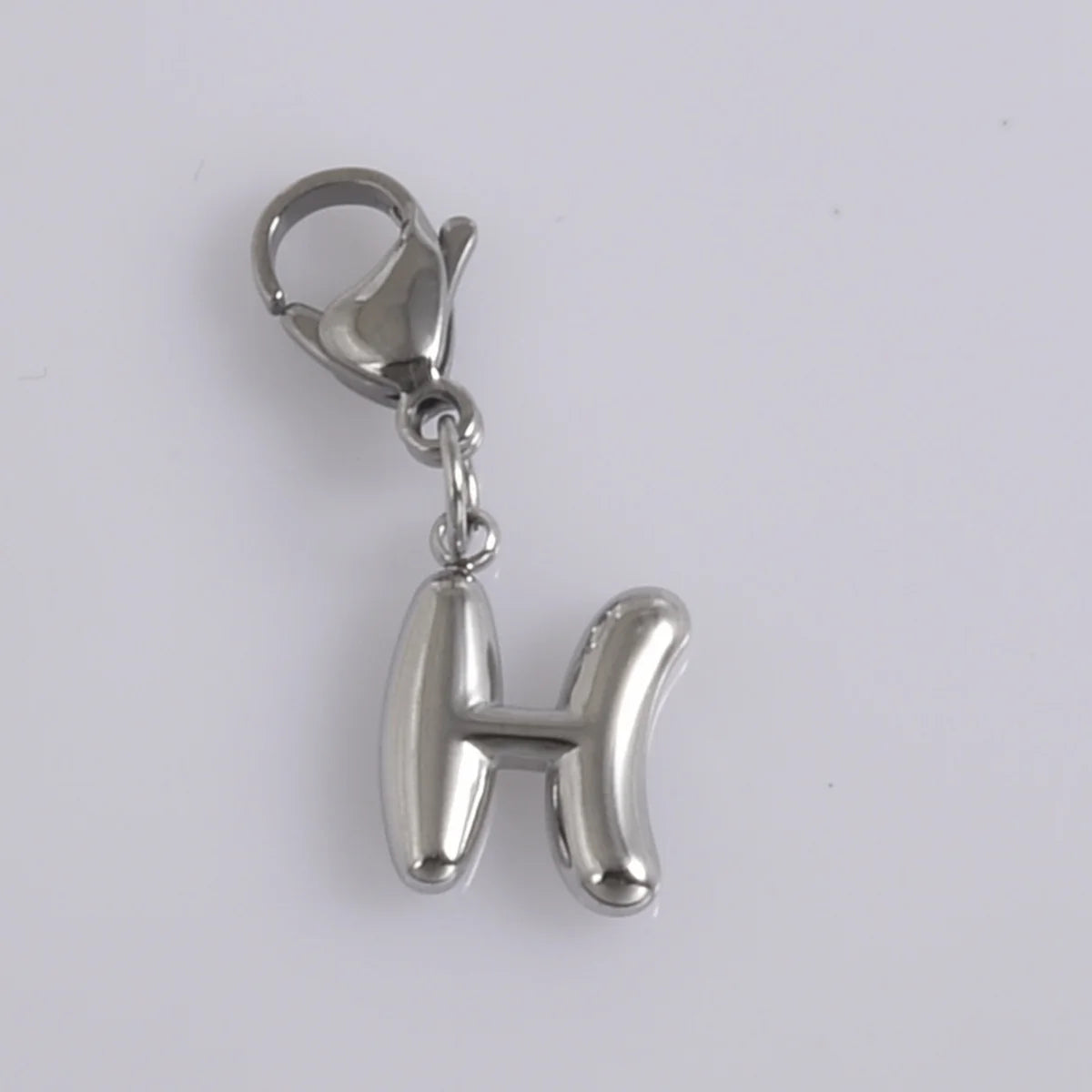 Silver stainless steel alphabet letter charm with a lobster clasp.