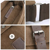 Close-up of a brown canvas messenger bag featuring dark brown leather accents and silver hardware.
