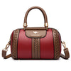 A maroon leather shoulder bag with gold hardware and a woven pattern on the front.