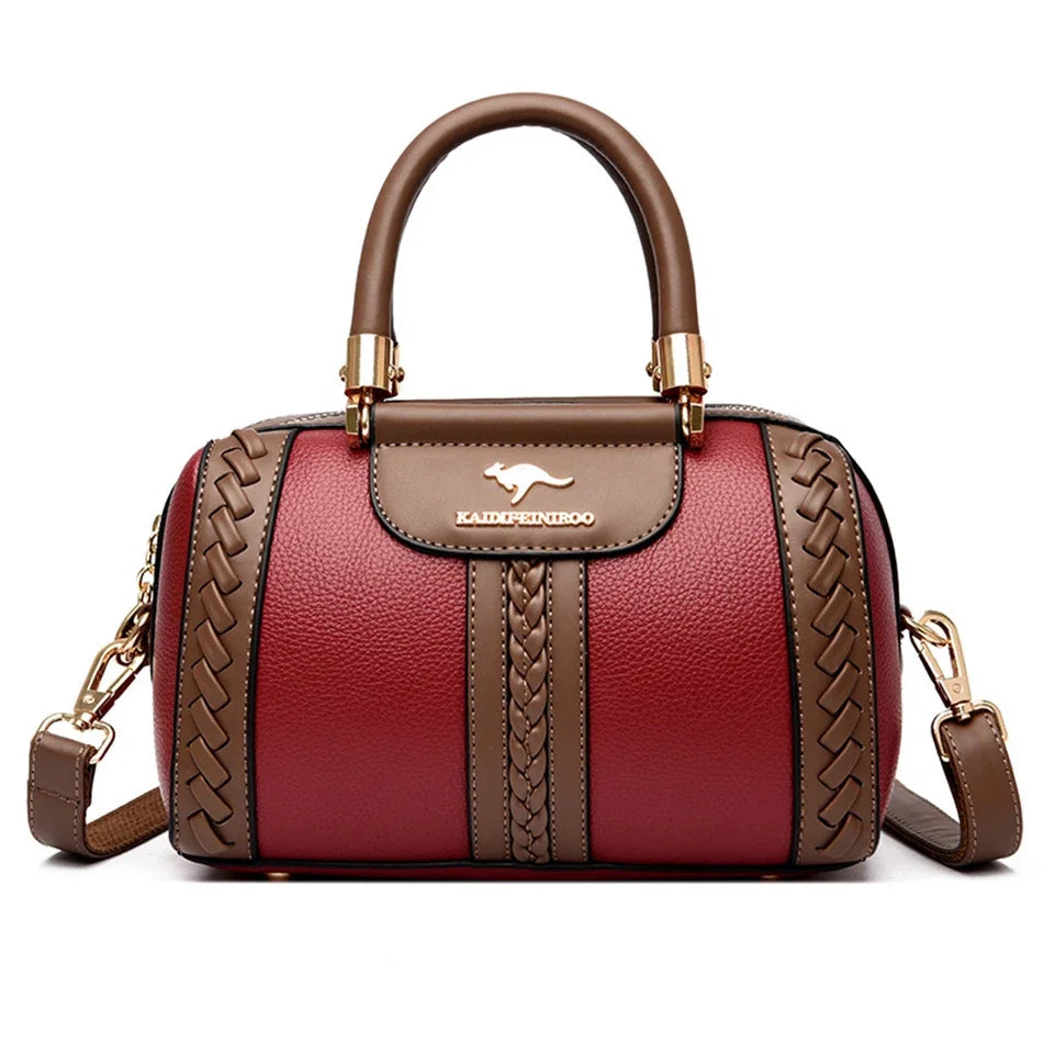 A maroon leather shoulder bag with gold hardware and a woven pattern on the front.
