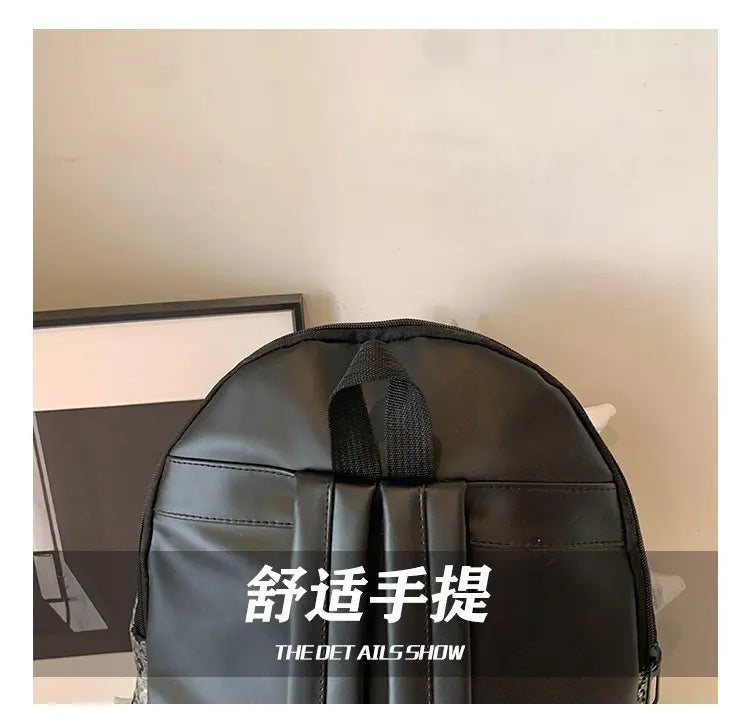 A black hedgehog-shaped PU backpack shown from the top, featuring Chinese text.