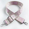 A beige and pink floral patterned adjustable strap for a crossbody bag.