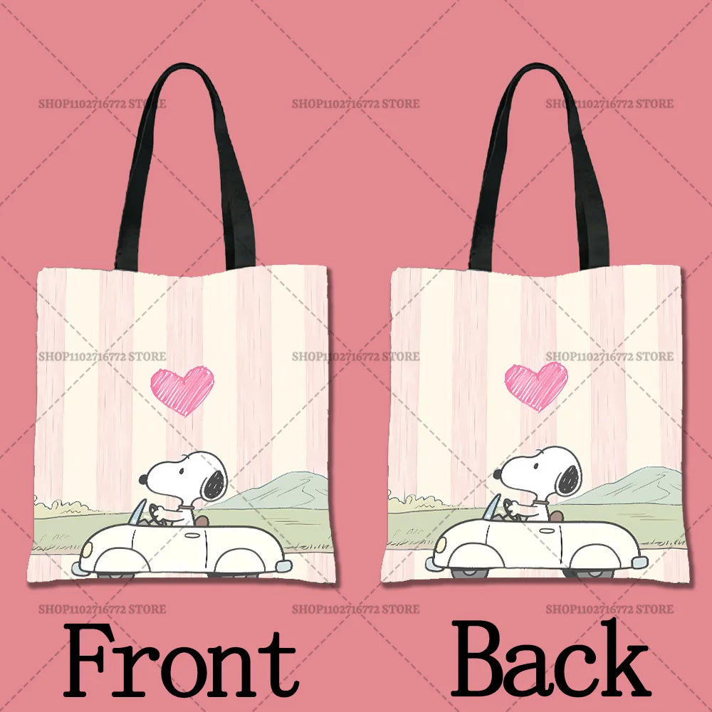 A pink canvas tote bag featuring a cartoon drawing of Snoopy on the front and back.