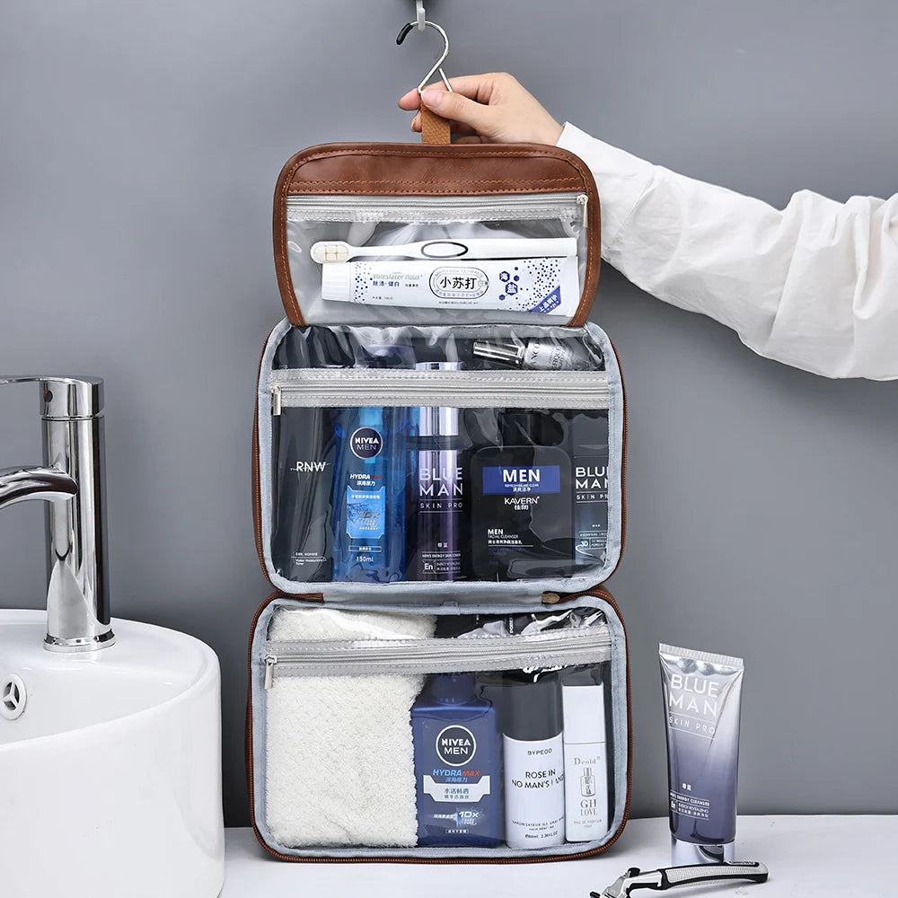 A brown cosmetic organizer bag with clear compartments and a white dispenser is being held by a hand.