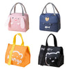 Four cartoon insulated lunch bags in pink, blue, orange, and black with gray handles.