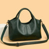 A dark green leather women's casual crossbody shoulder bag with a strap resting on a light background.