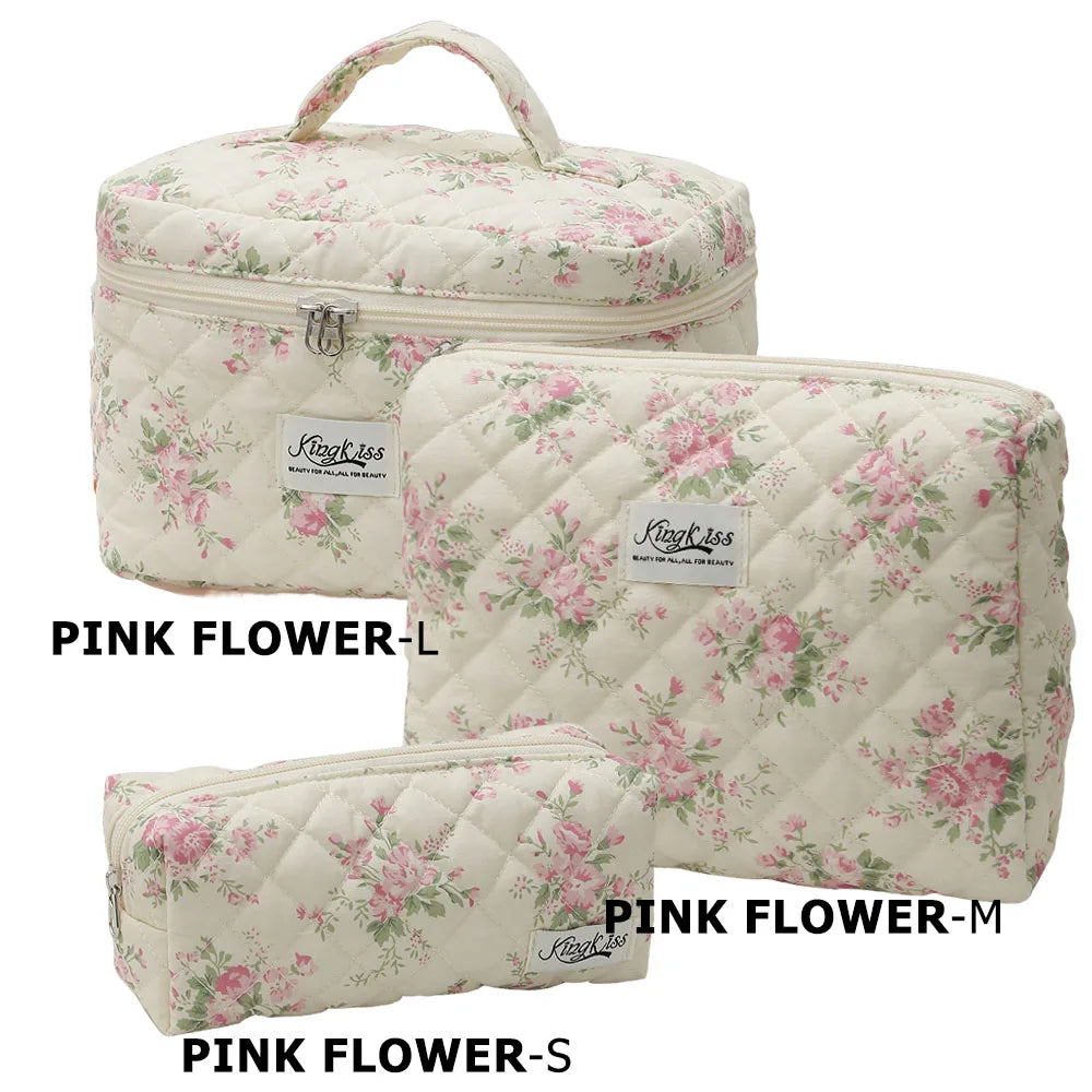 A set of three pink floral quilted cotton makeup organizers in sizes Large, Medium, and Small.