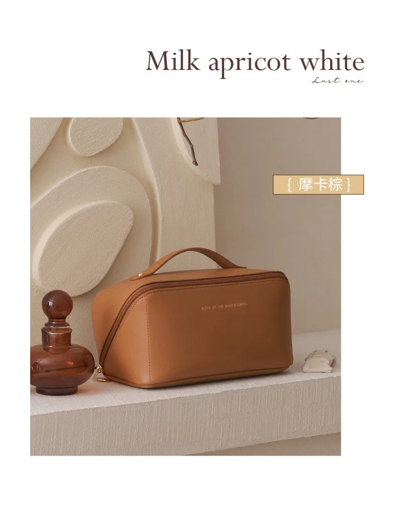 A brown cosmetic storage bag is displayed next to a glass bottle on a light surface.