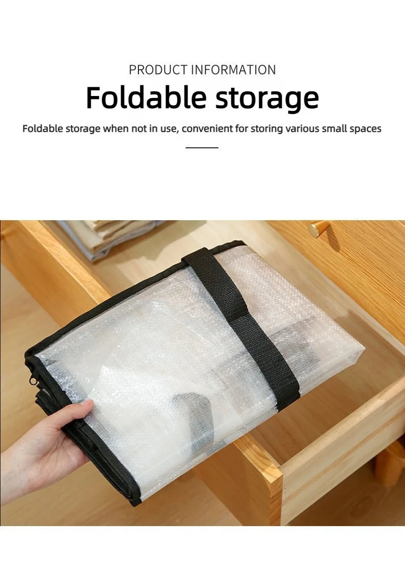 A hand holds a large transparent woven storage bag with black double zippers inside a wooden box.