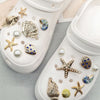 White cosmetic case filled with various gold and iridescent sea creature shoe charms
