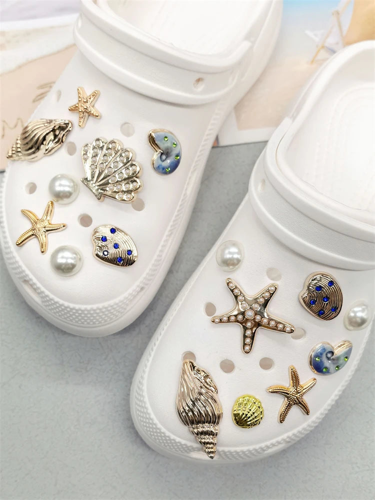 White cosmetic case filled with various gold and iridescent sea creature shoe charms