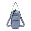 A light blue adjustable strap thermal water bottle bag with a separate pocket and shoulder straps.