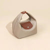 A light beige waterproof nylon crossbody bag with dual brown straps shown from above.