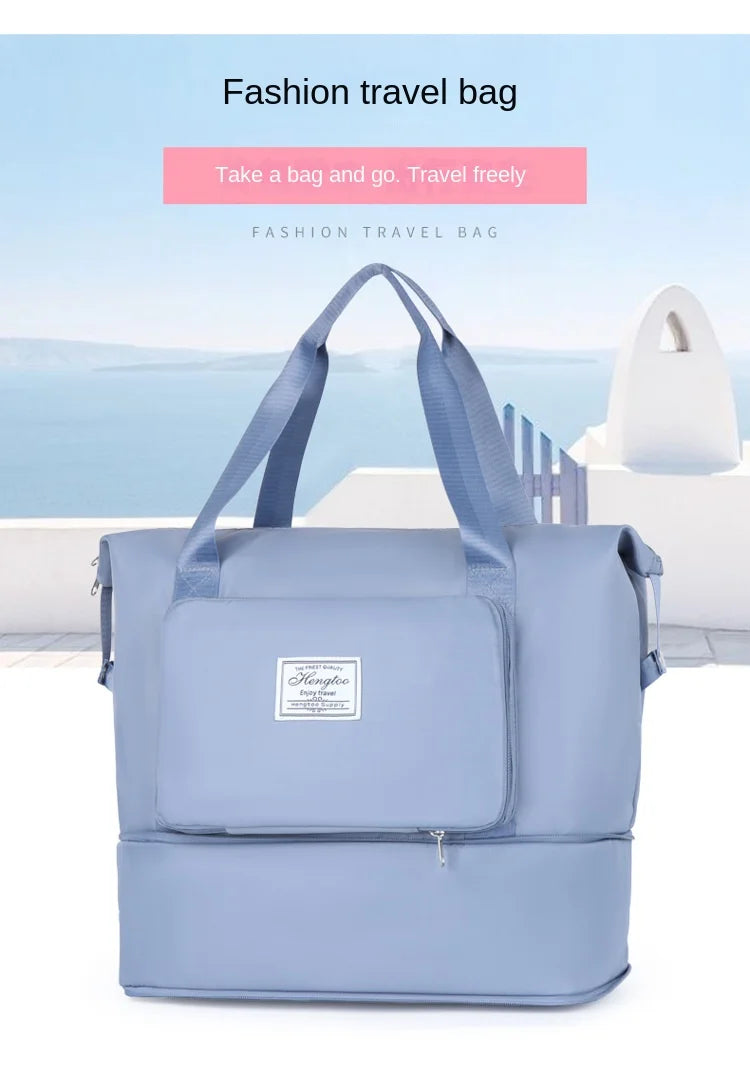 A light blue fashion travel bag with shoulder straps is displayed outdoors against a backdrop of the sea and sky.