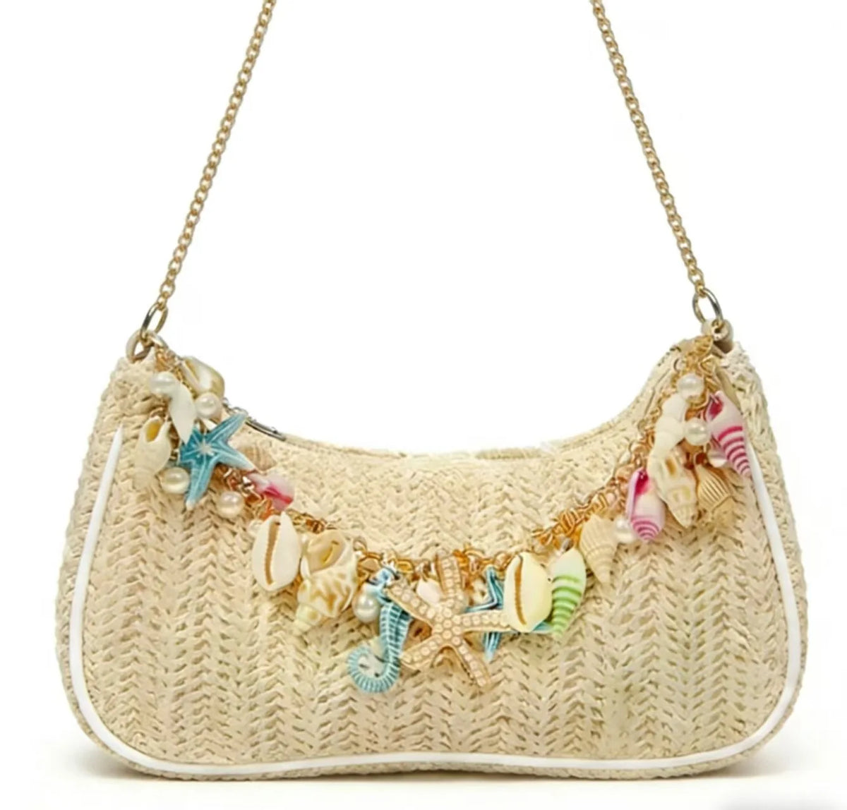 A beige woven straw shoulder bag adorned with colorful starfish and seashell charms.